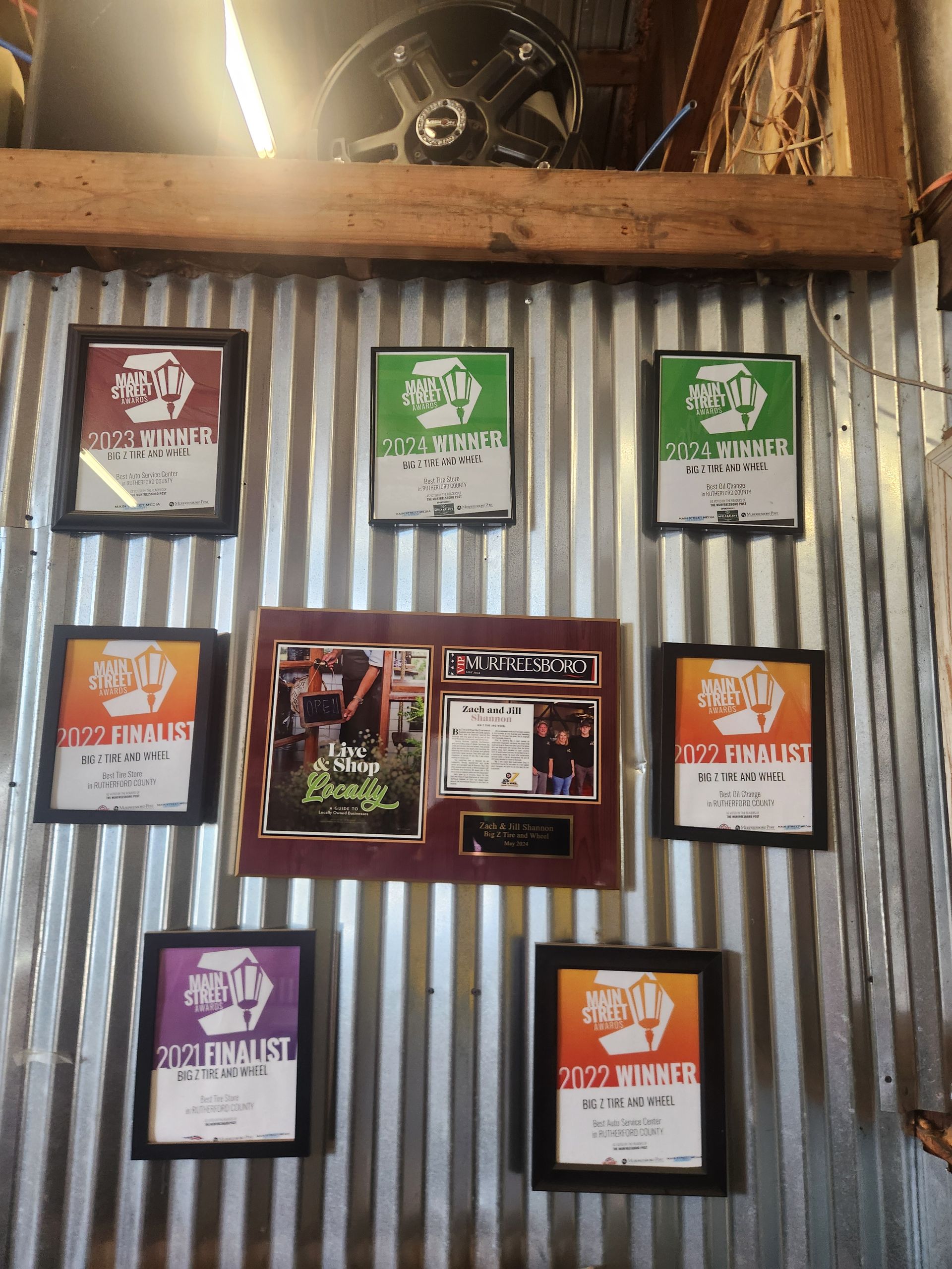 Corrugated metal wall with framed menus and photos in a rustic restaurant setting