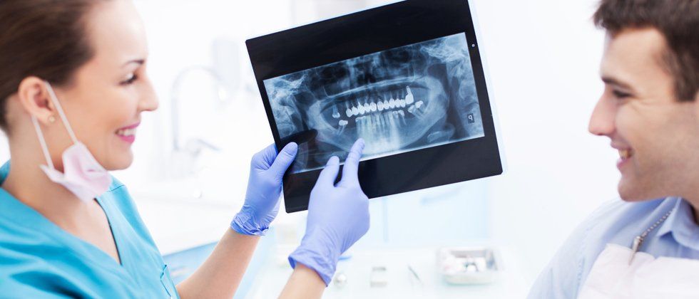 Dentist showing man his teeth x-ray