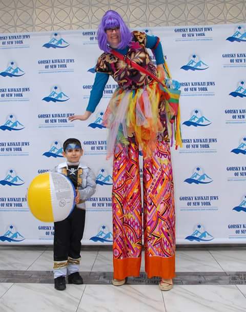 Tall performer with a little kid