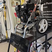 Pressure washer engine on metal stand.