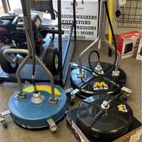 Four power washer surface cleaners on display.