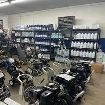 A store with many pressure washers and shelves of cleaning supplies.