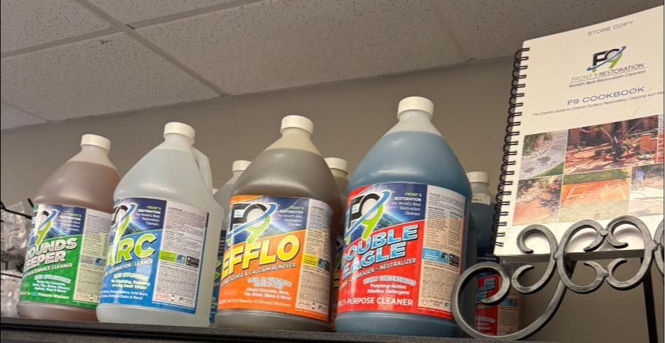 Shelves with jugs of cleaning solutions and a brochure in a store setting.