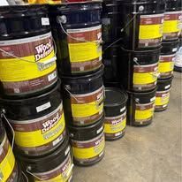 Paint cans stacked. Black and blue cans with 