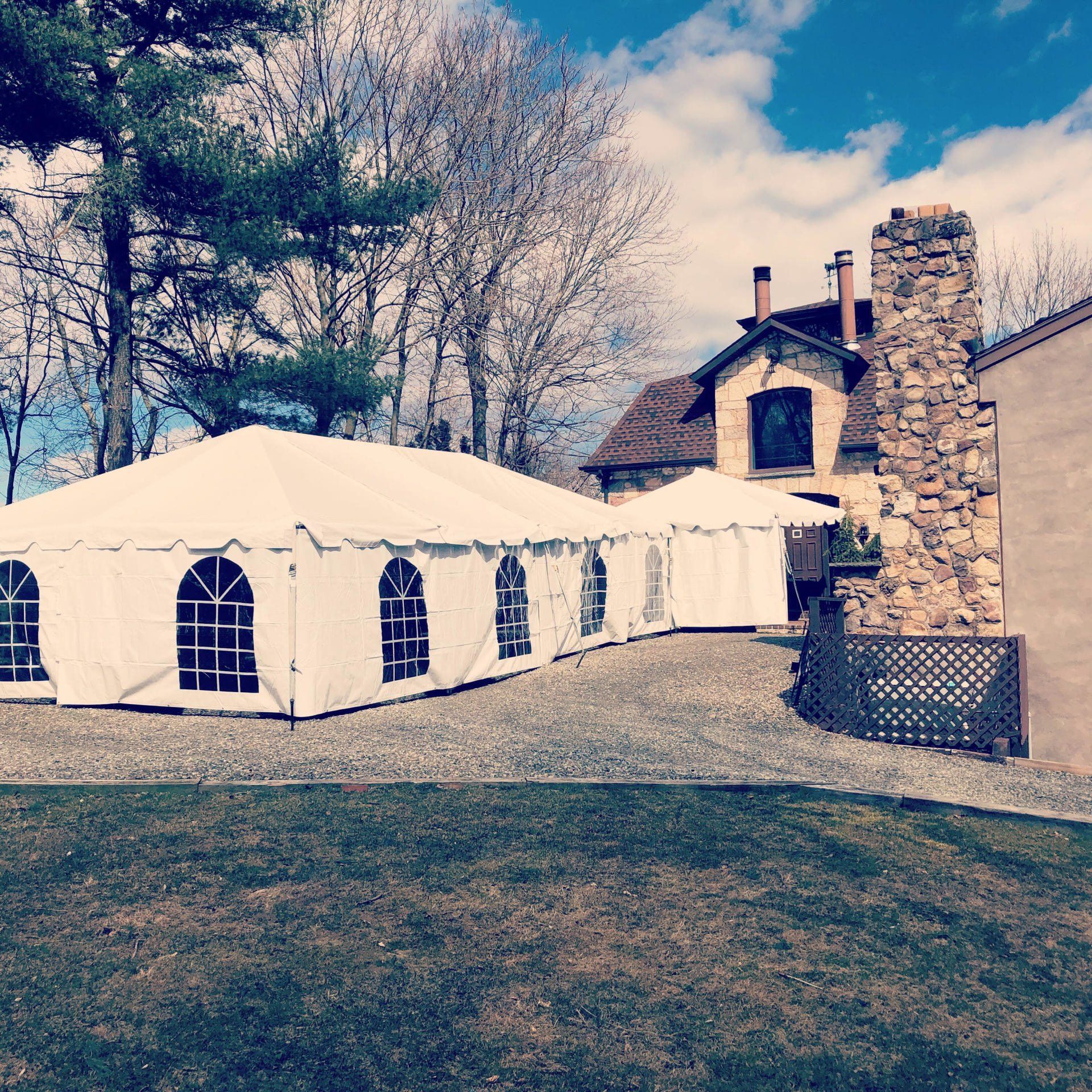 a white tent with windows in front of a house