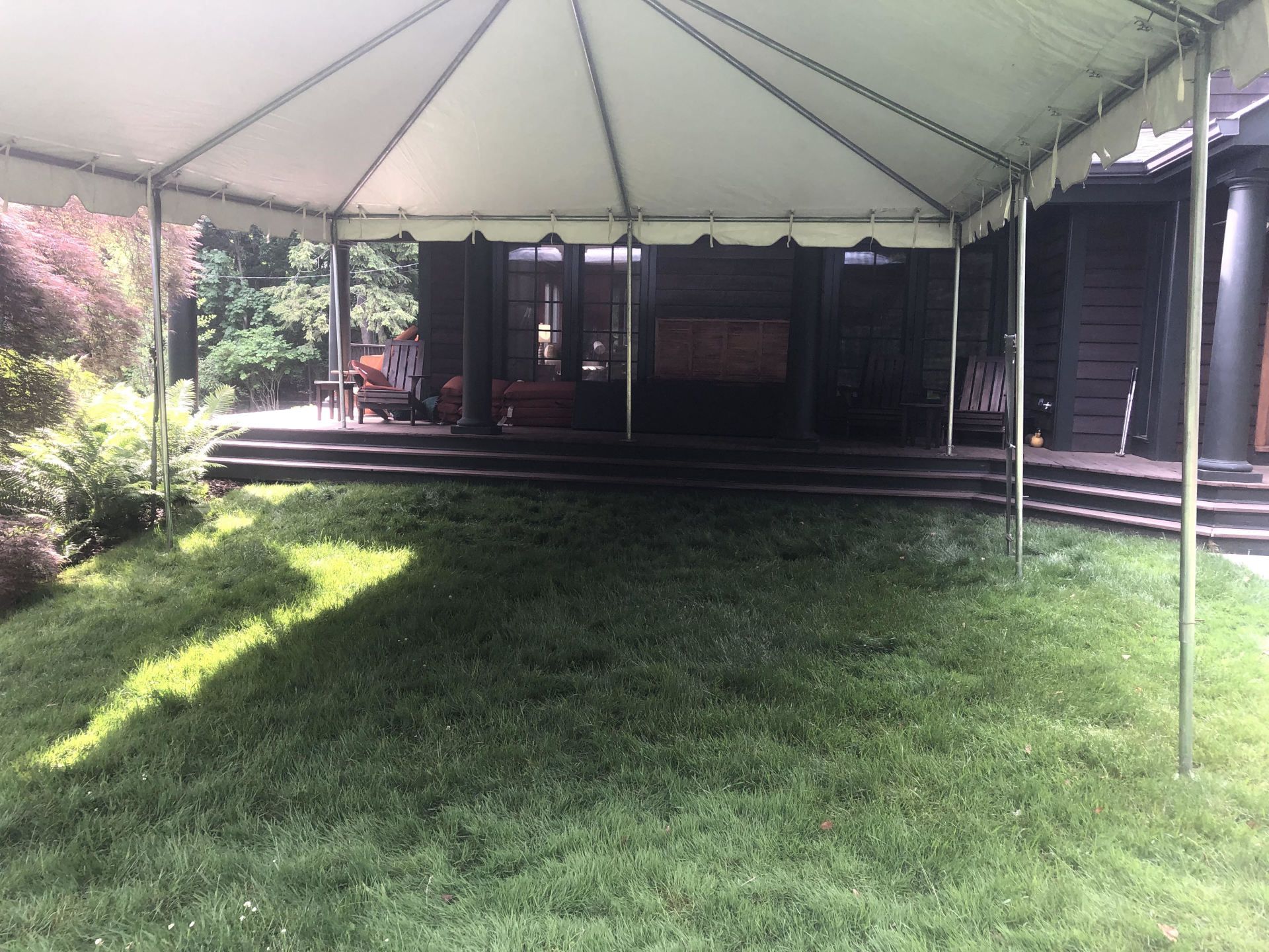 a tent with a lawn and a porch