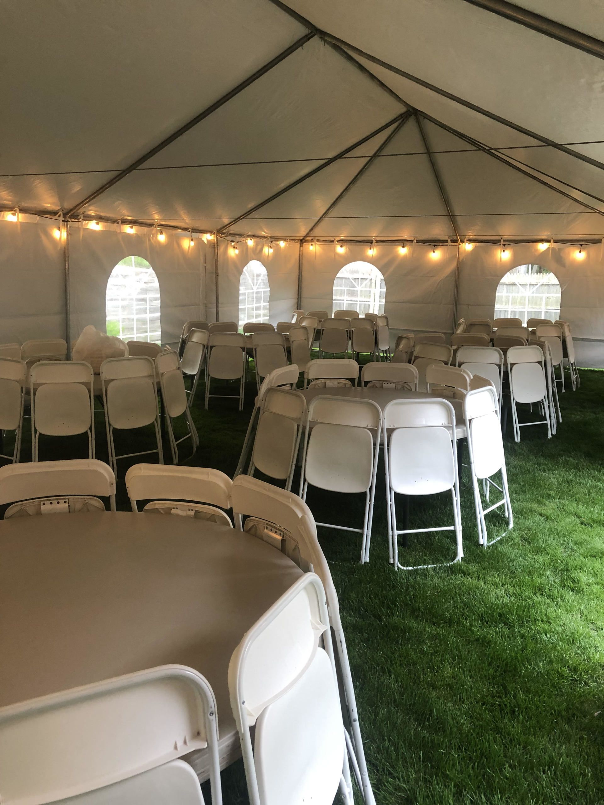 a white tent with tables and chairs