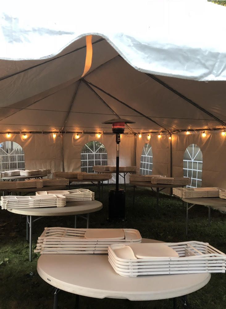 a tent with tables and chairs