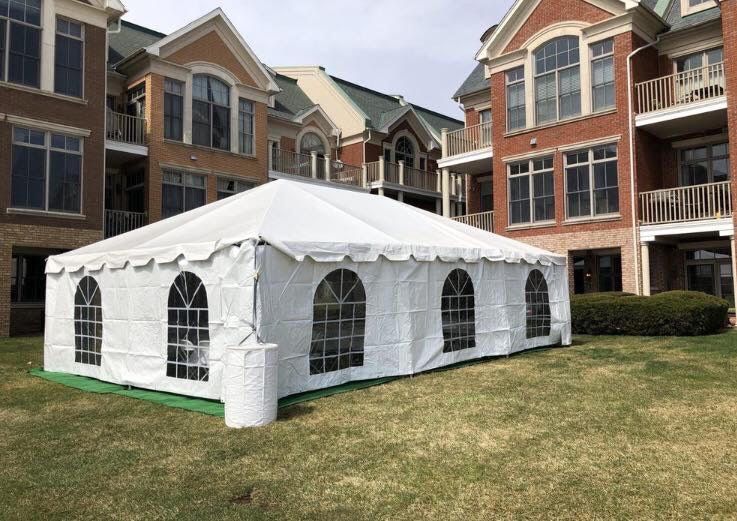 a white tent in front of a building