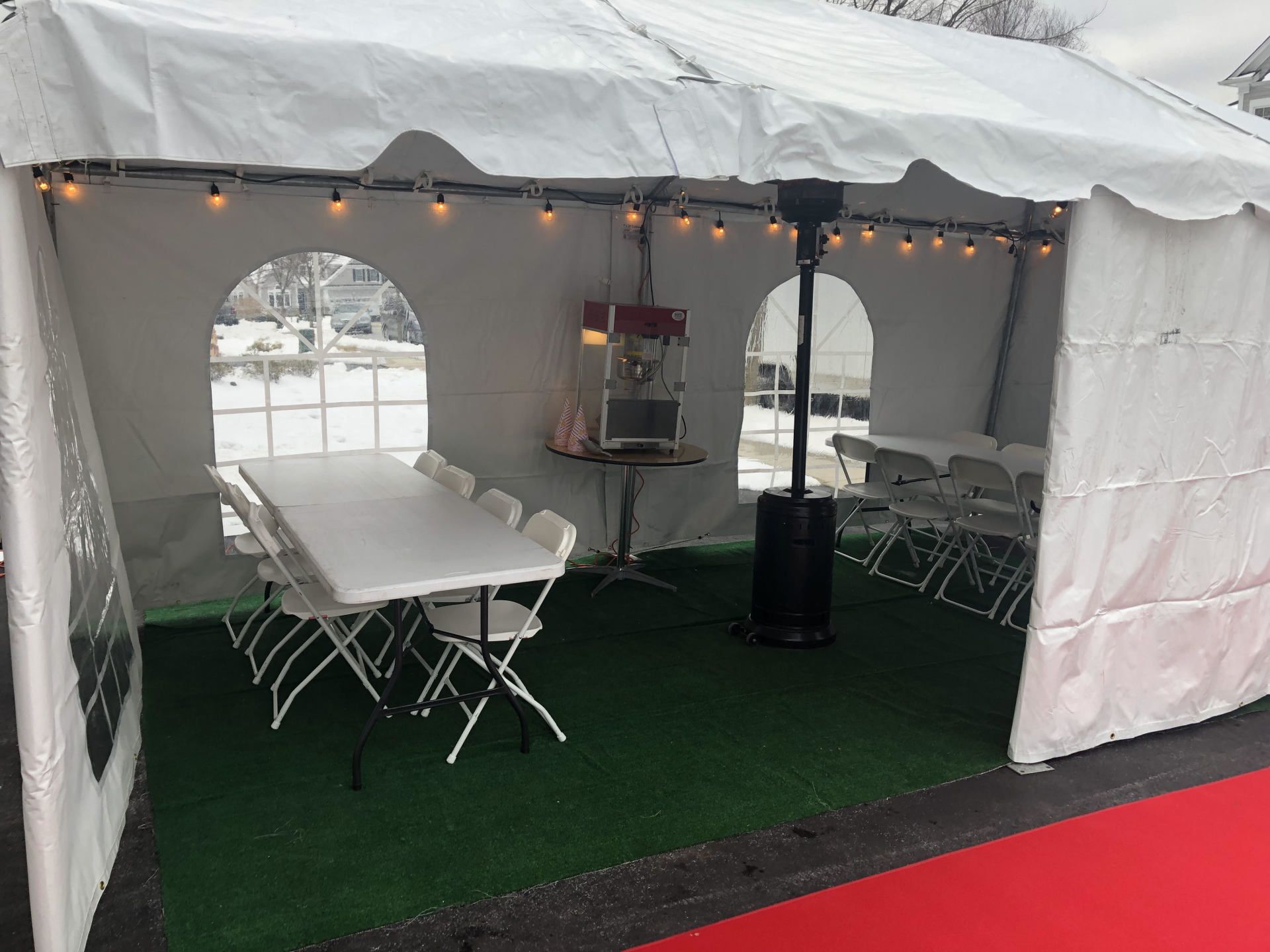 a white tent with tables and chairs