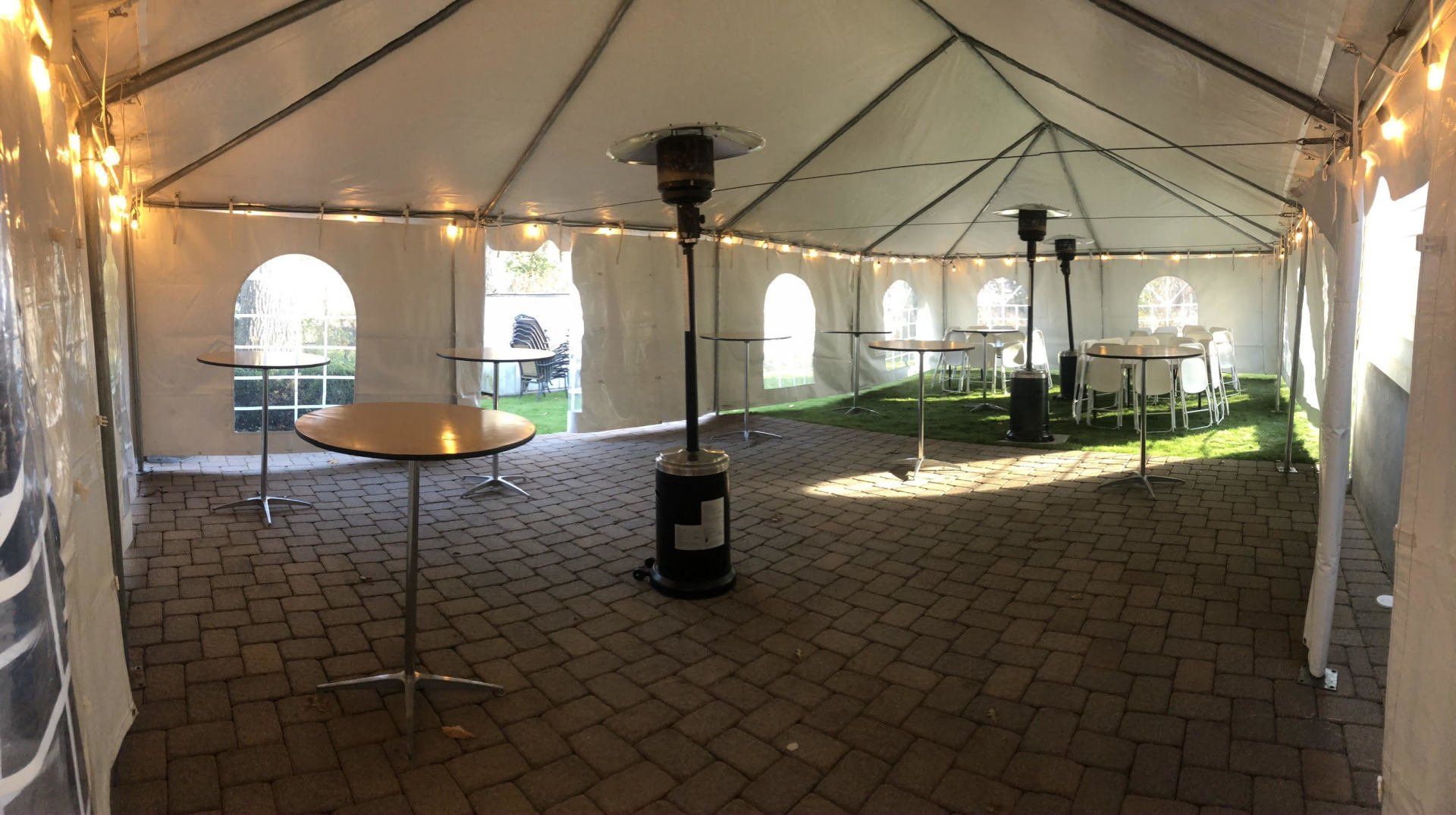 a tent with tables and chairs