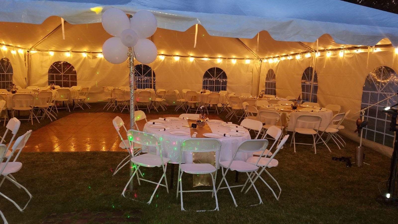 a white tent with tables and chairs