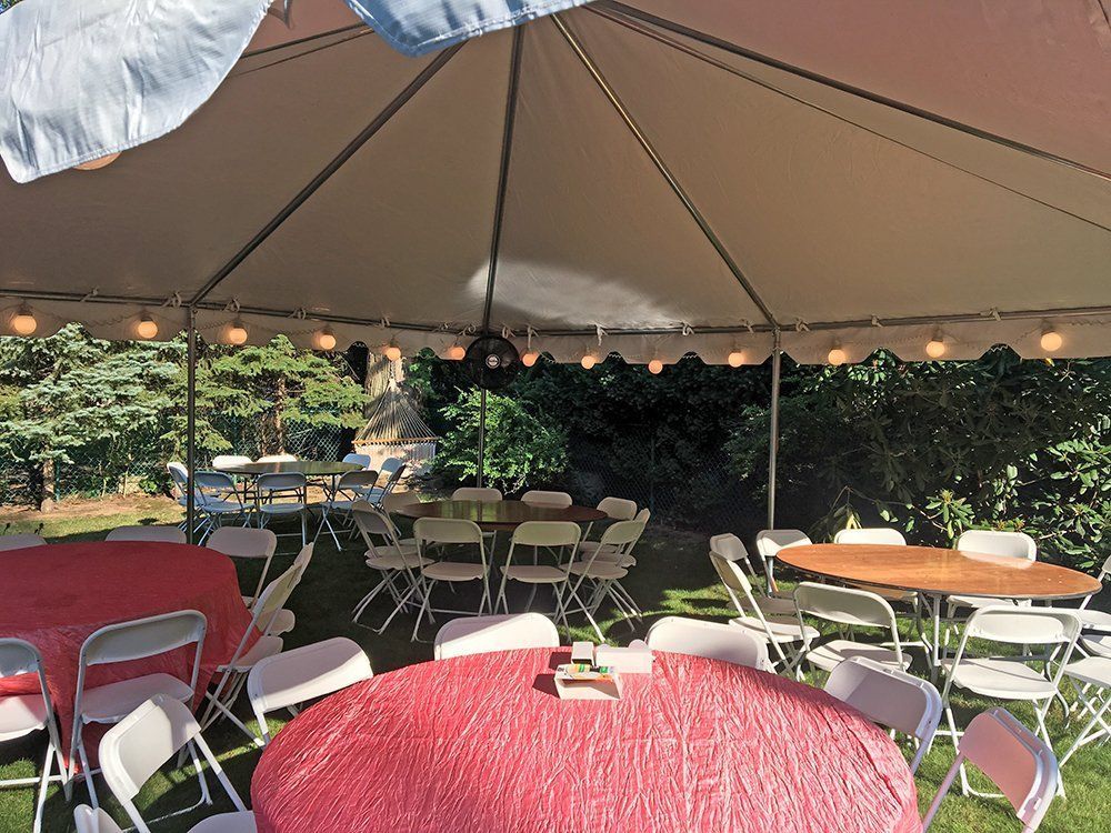 a tent with tables and chairs