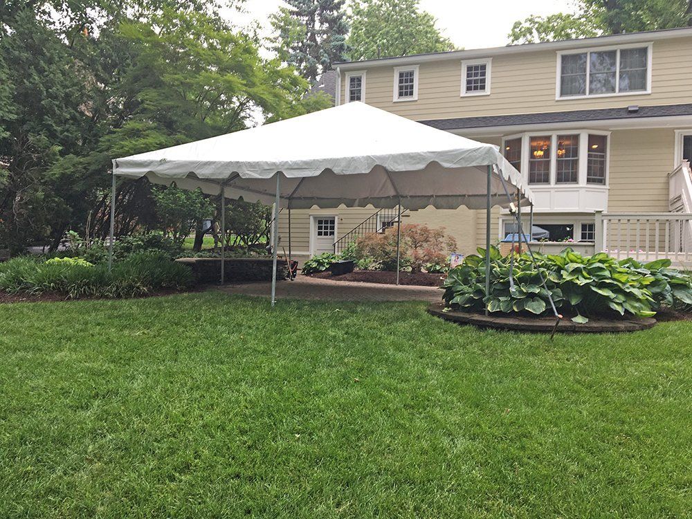 a white tent in front of a house