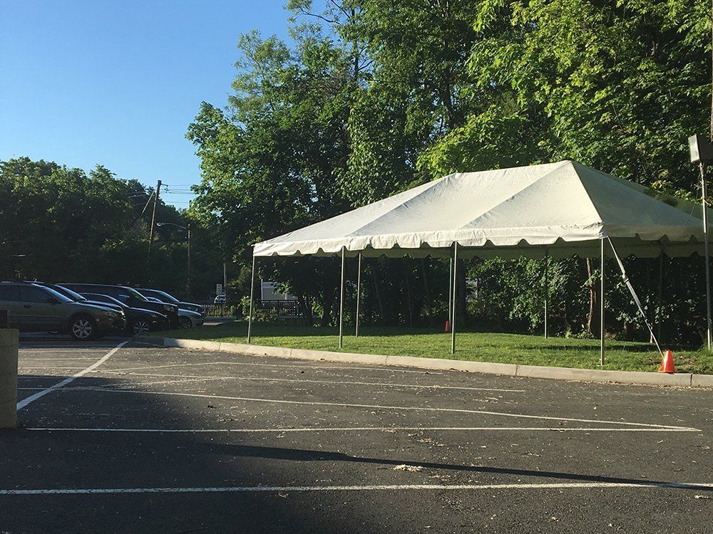 a white tent in a parking lot