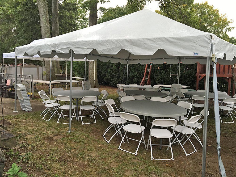 a tent with tables and chairs