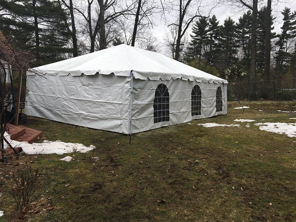 a white tent in a grassy area