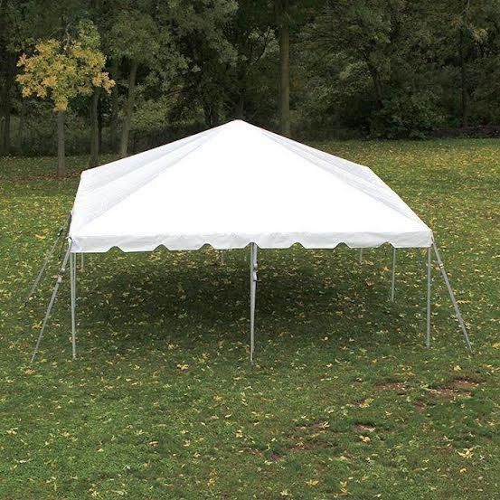 a white tent in a grassy area
