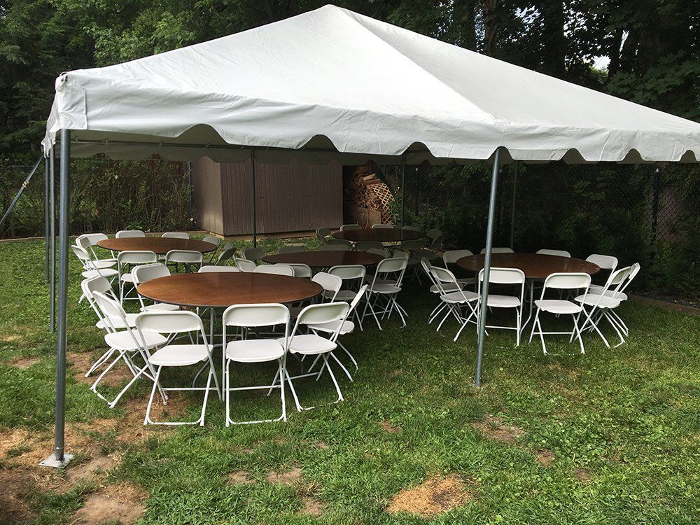 a table and chairs under a tent