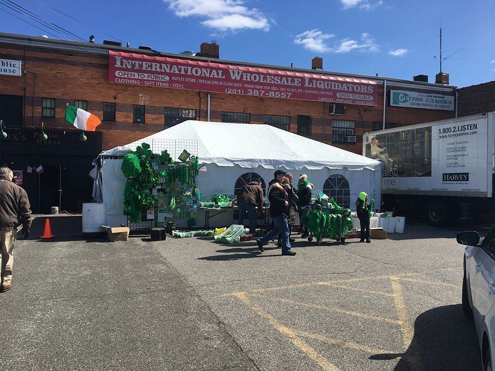a group of people outside a white tent