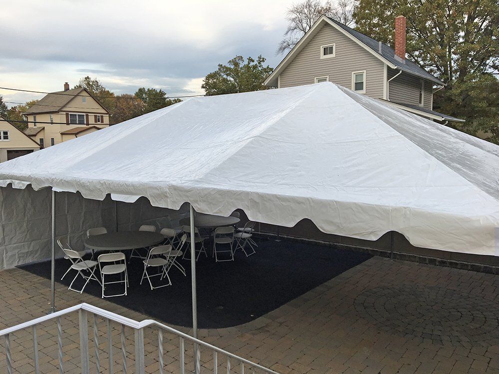 a white tent with tables and chairs