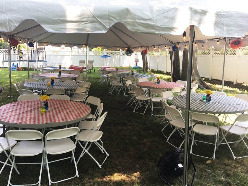 tables and chairs under a tent