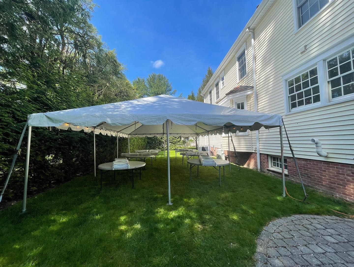 a white tent in a yard
