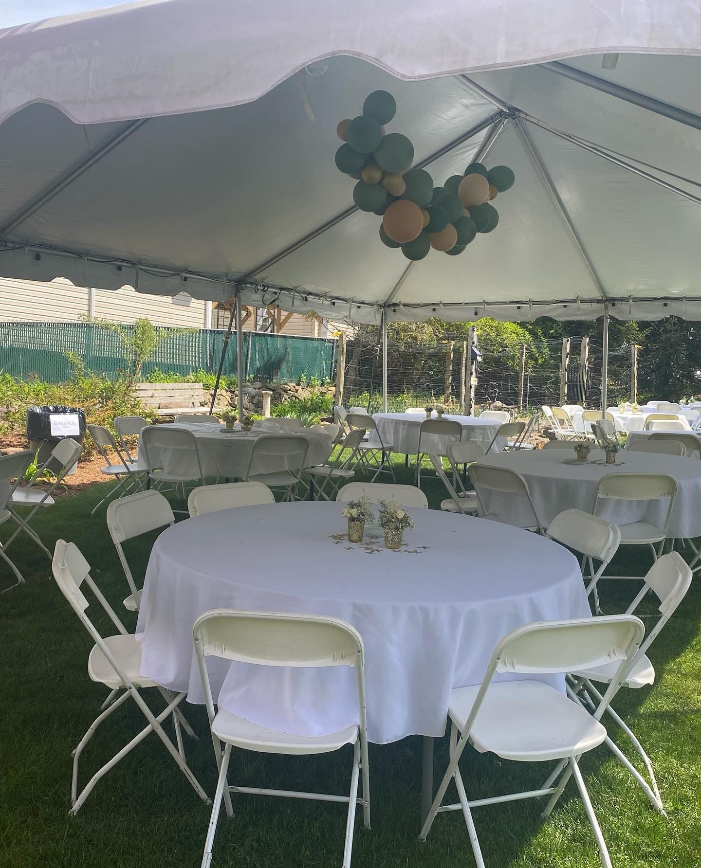 a white table and chairs under a tent