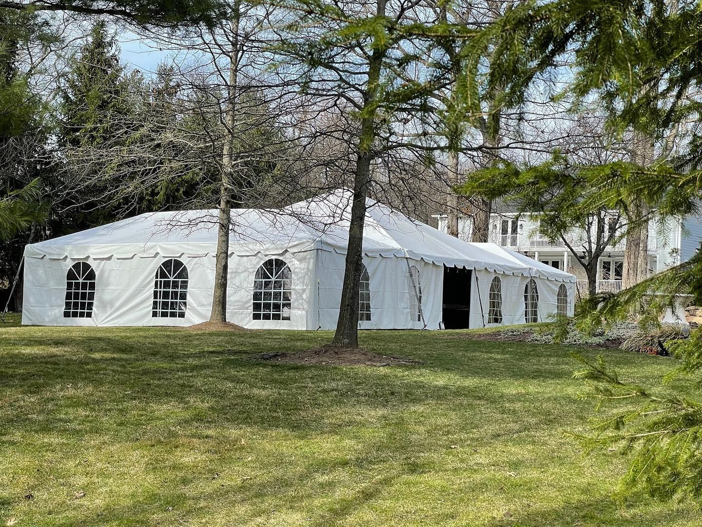 a white tent in a grassy area