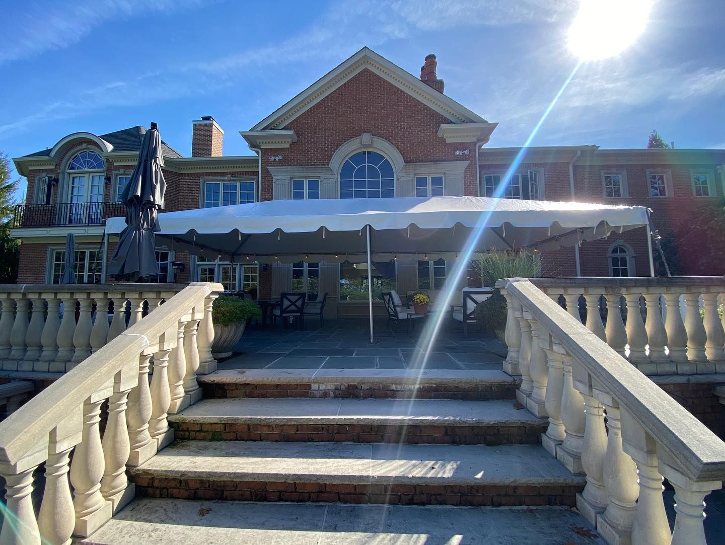 a building with a large patio and a large umbrella