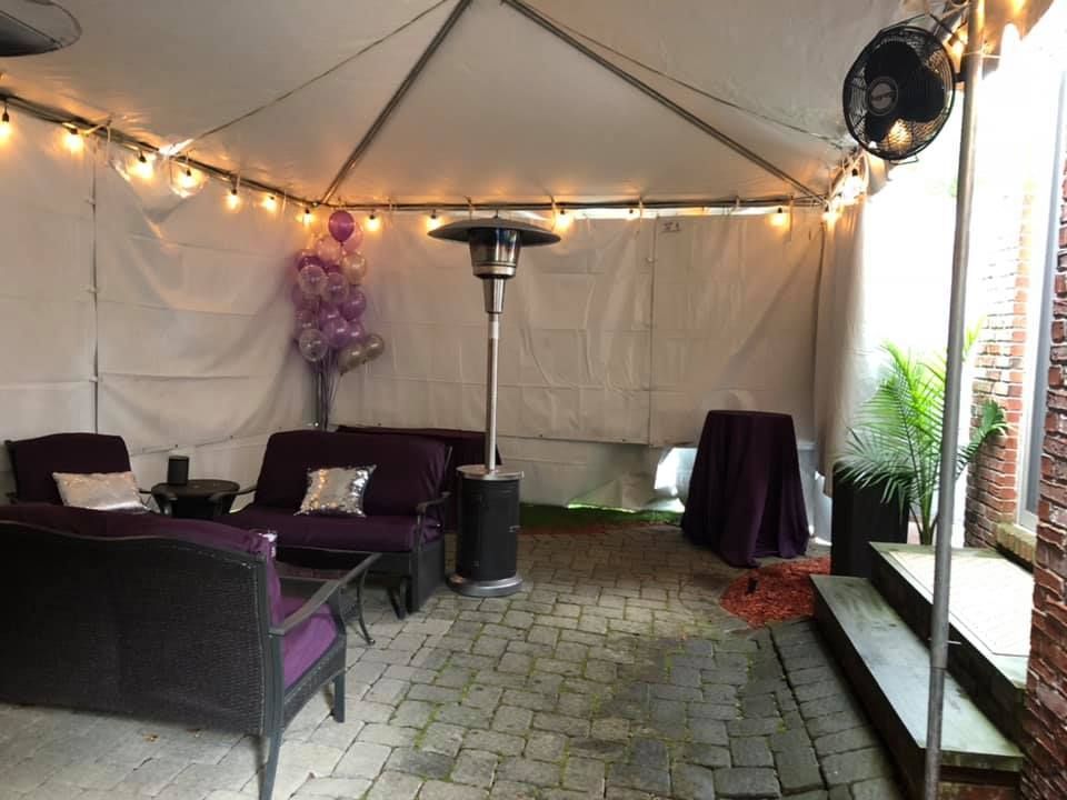 a tent with a couch and balloons