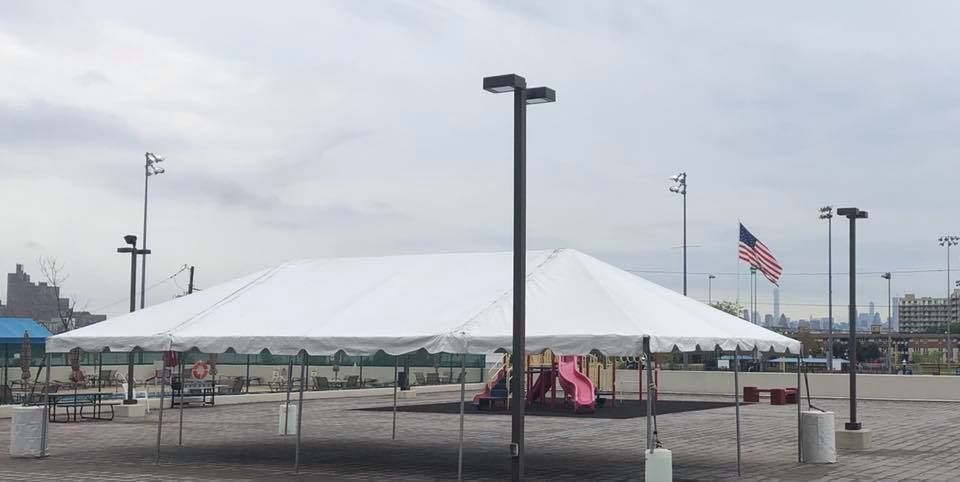 a white tent with a slide and a playground