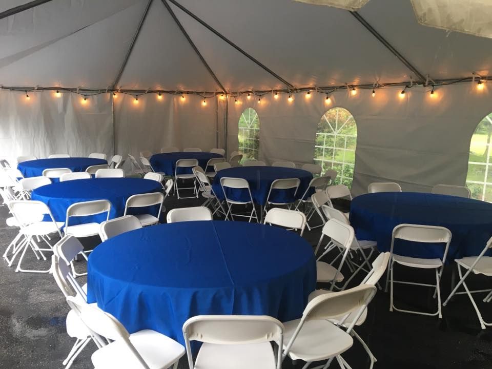 a group of tables and chairs in a tent