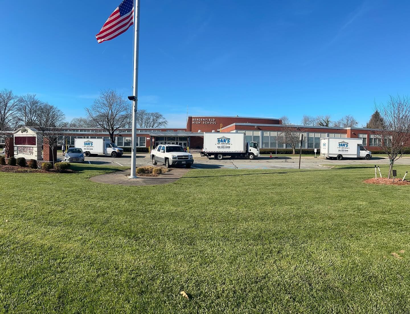 a group of white trucks in front of a building