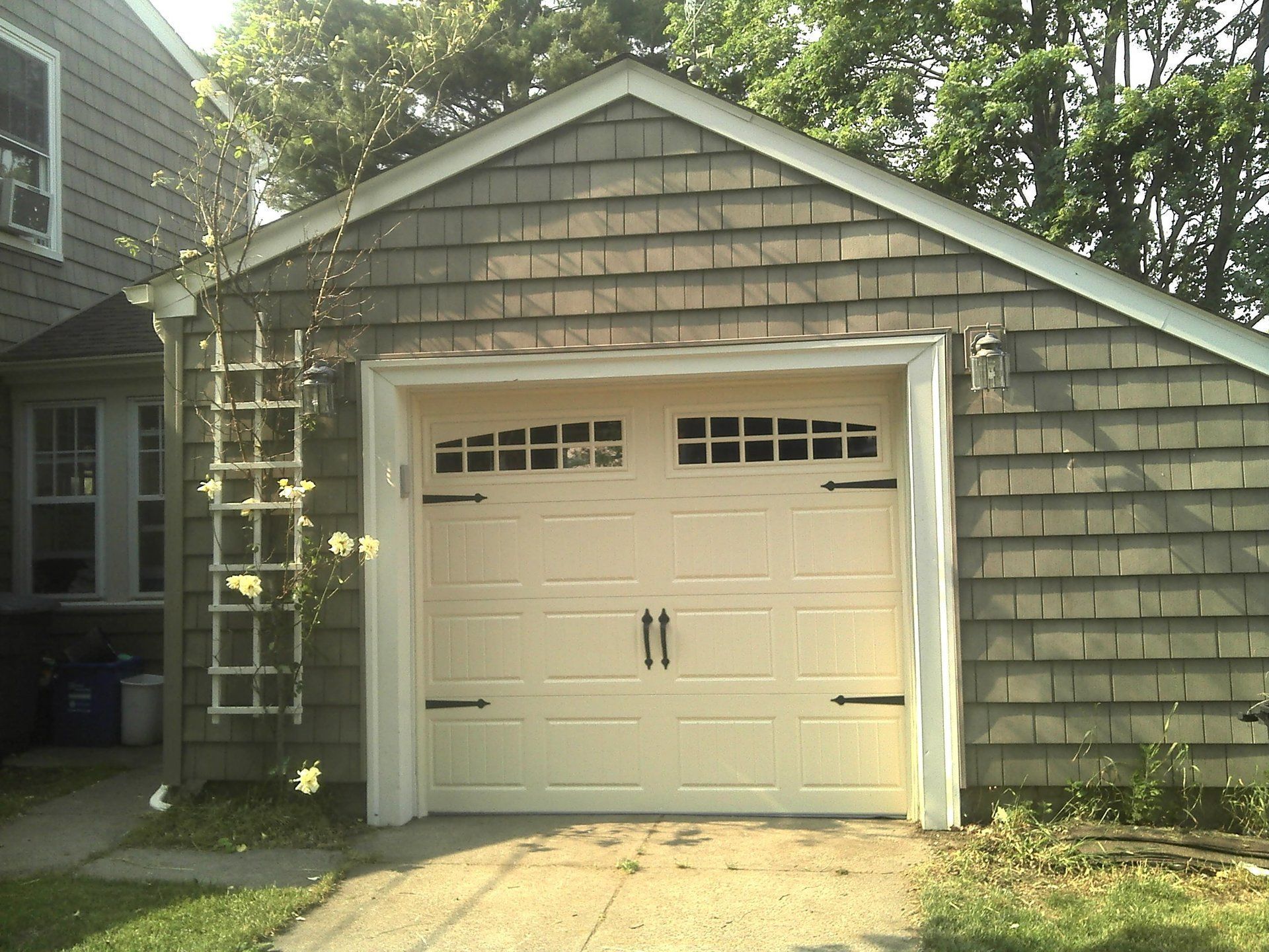 A garage with a white door and black handles