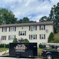 A truck and trailer are parked in front of a house.