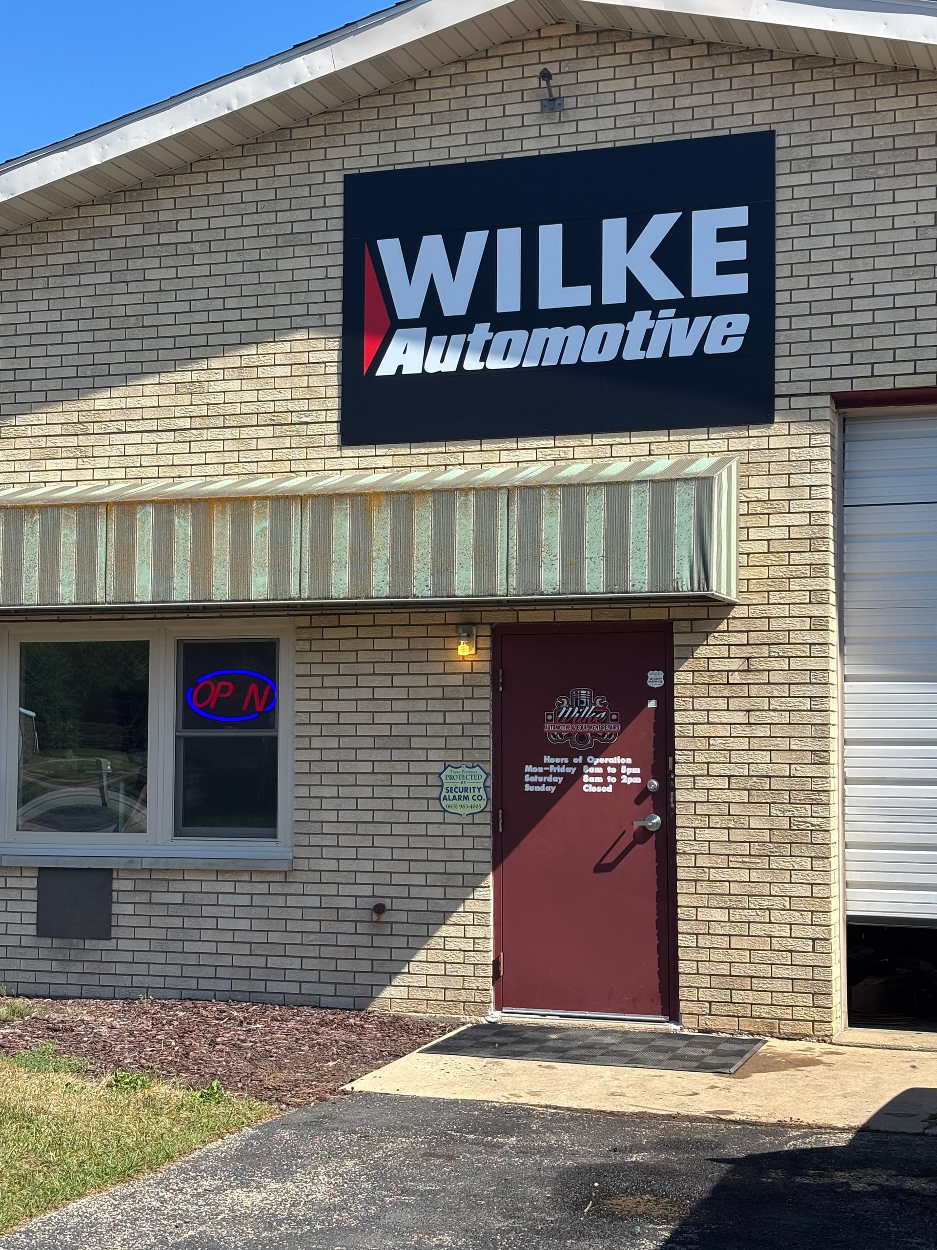 A brick building with a sign that says wilke automotive