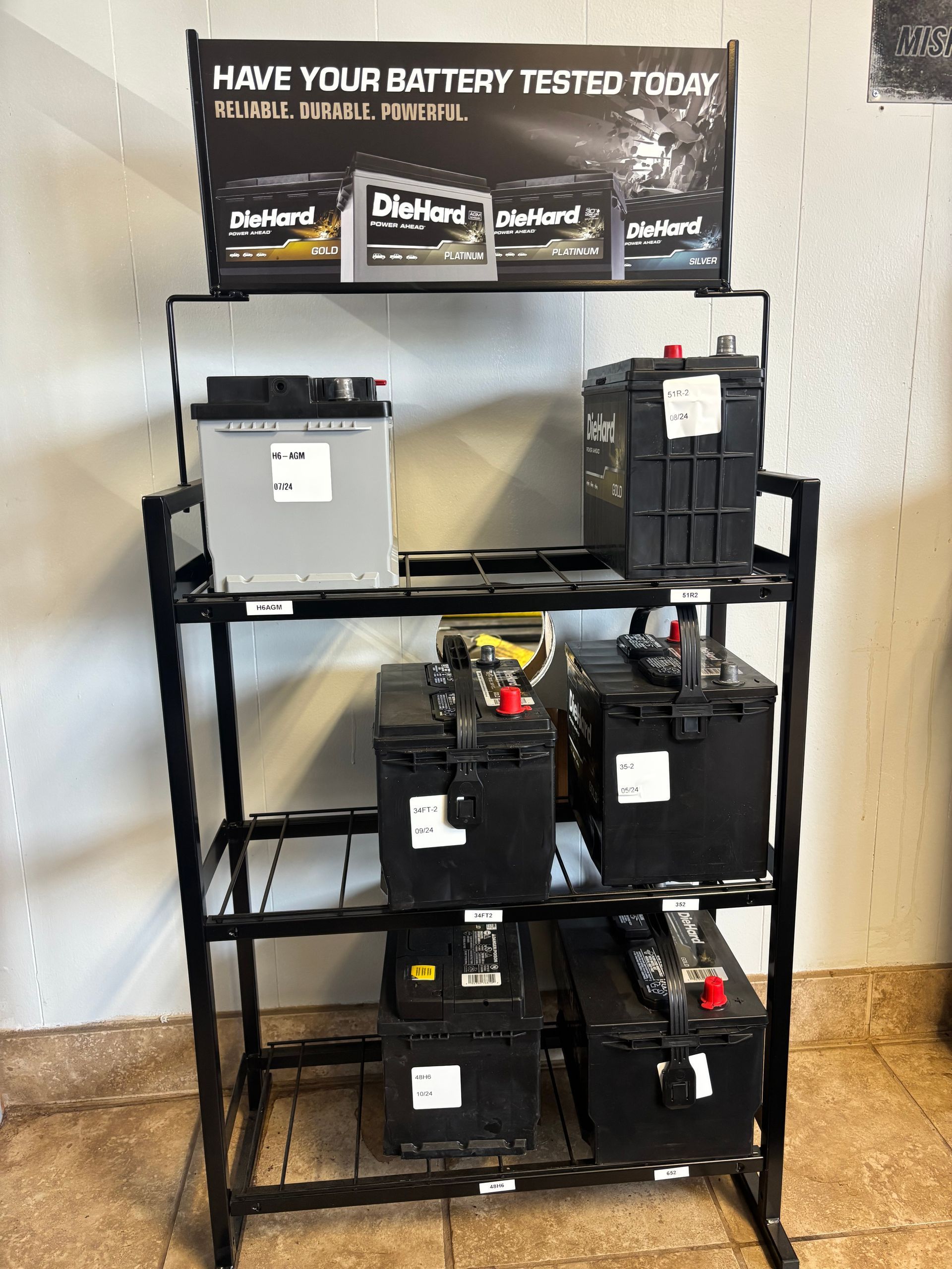 A display of batteries with a sign that says `` have your battery tested today ''