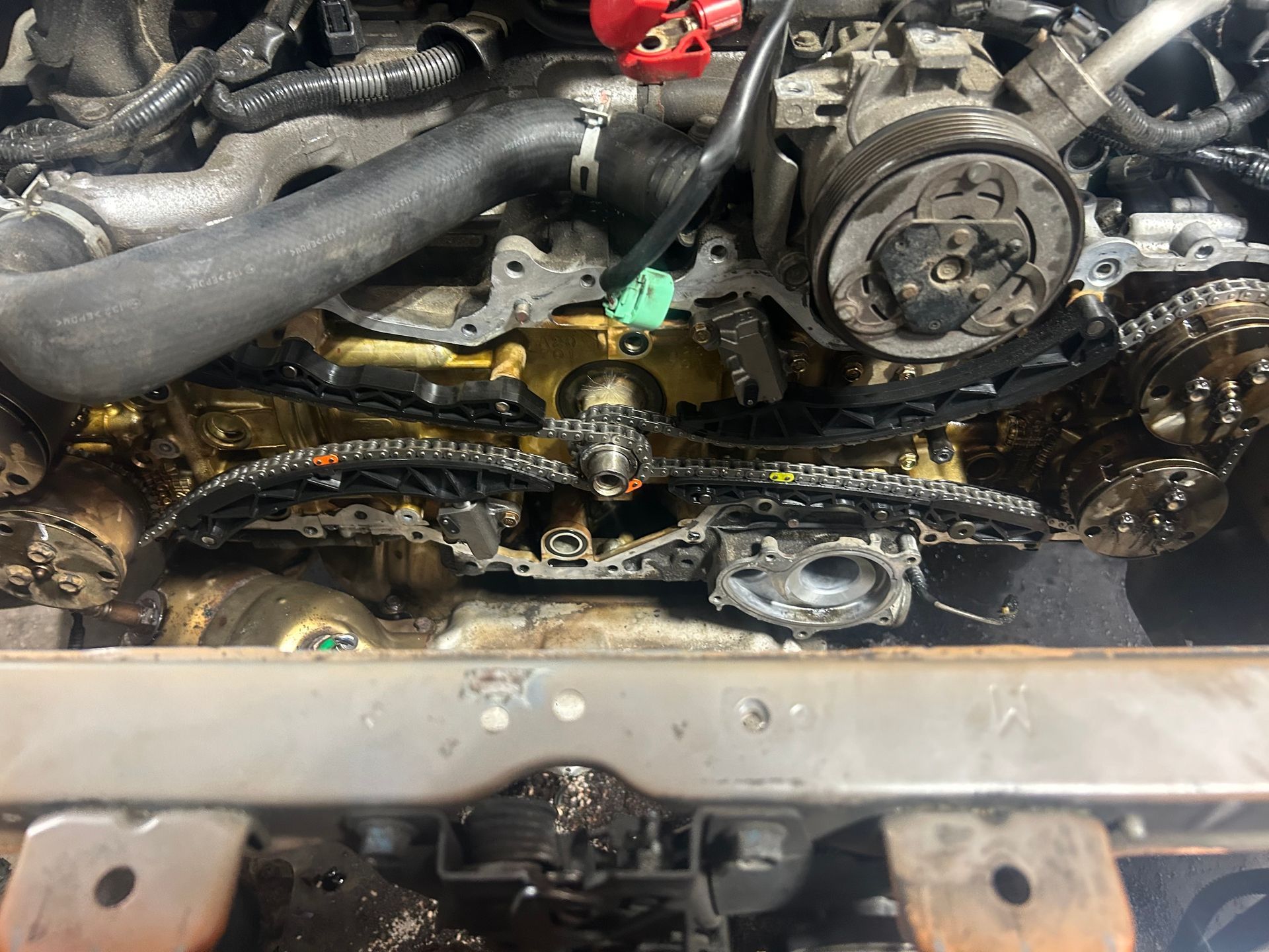 A close up of a car engine with the hood open.