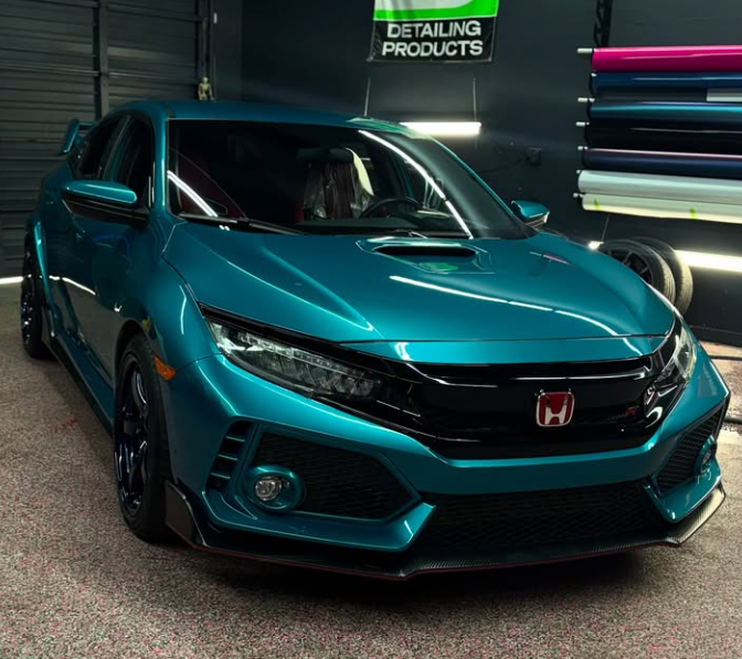 Teal Honda Civic Type R in a garage setting, with detailing products visible.