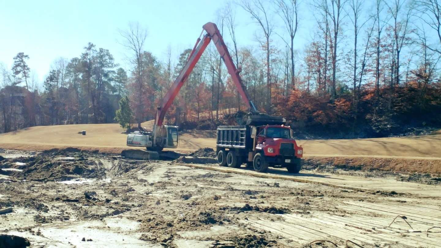 Backhoe and hauling truck