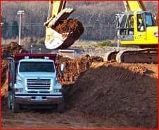 Hauling truck and backhoe