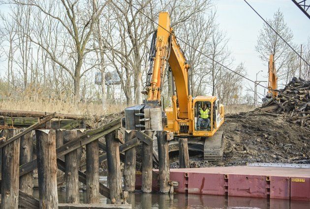 Backhoe clearing dock
