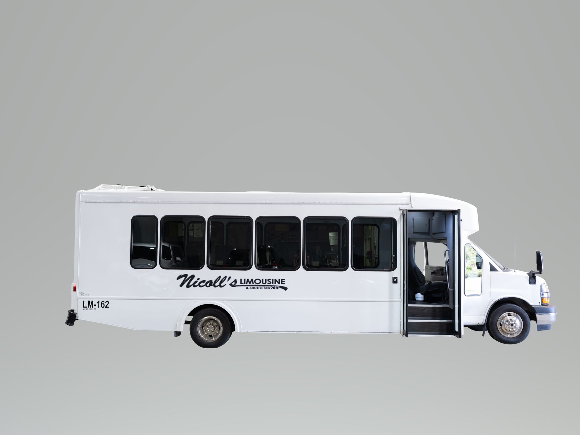 A white bus with the door open.