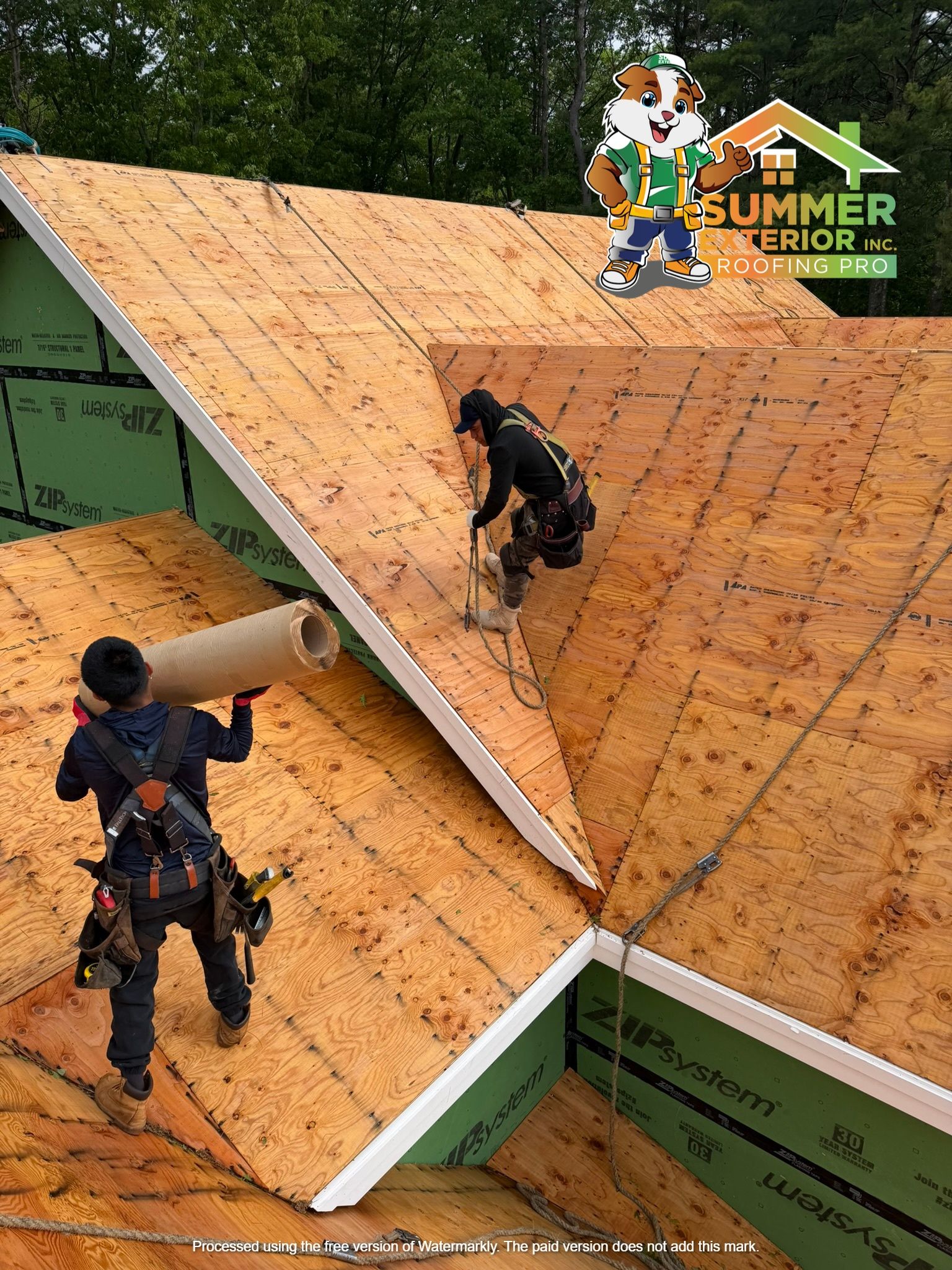 Workers installing shingles on a steep roof during an outdoor roofing competition.