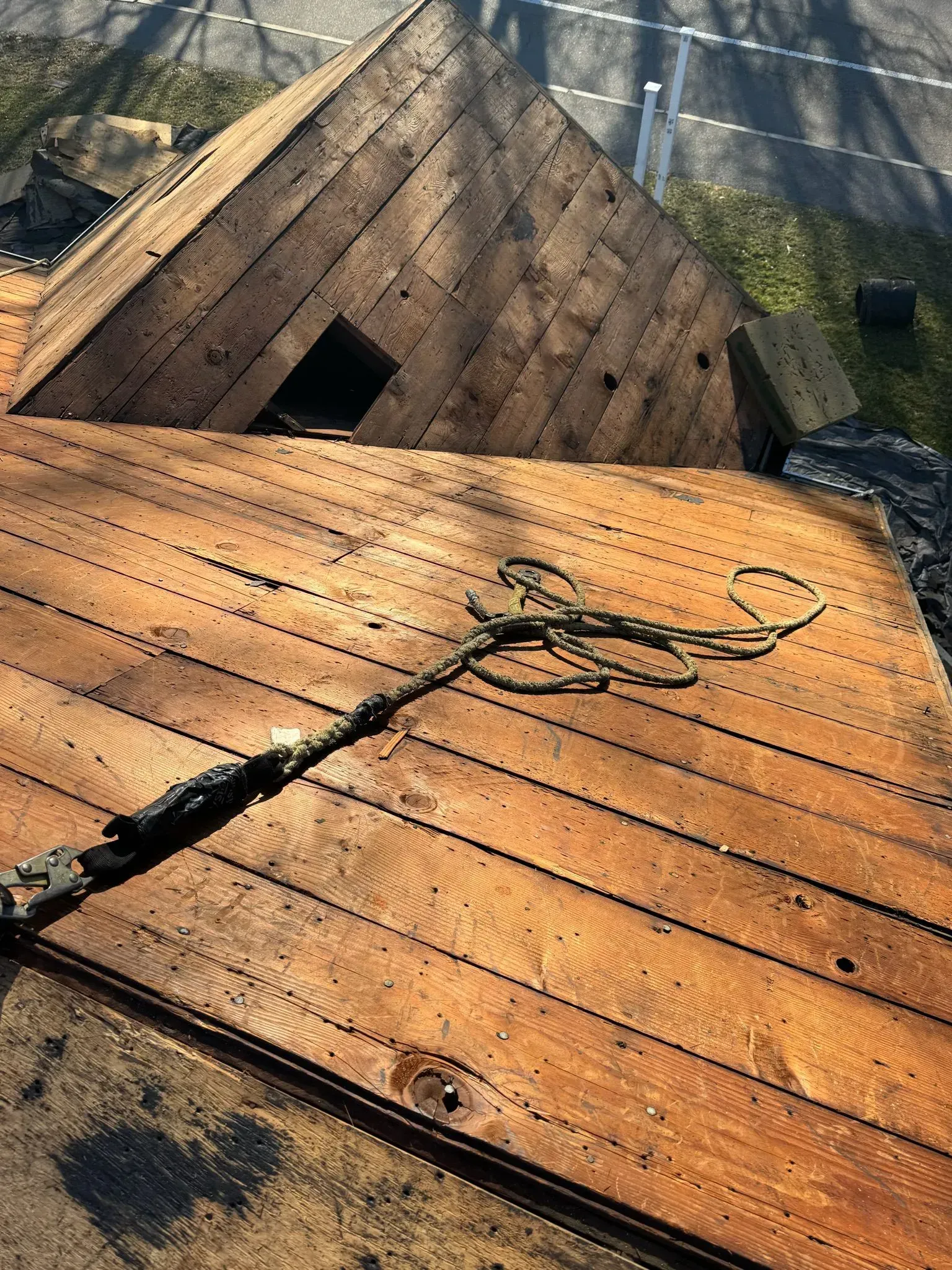 Brown wooden roof with a rope, view from above.