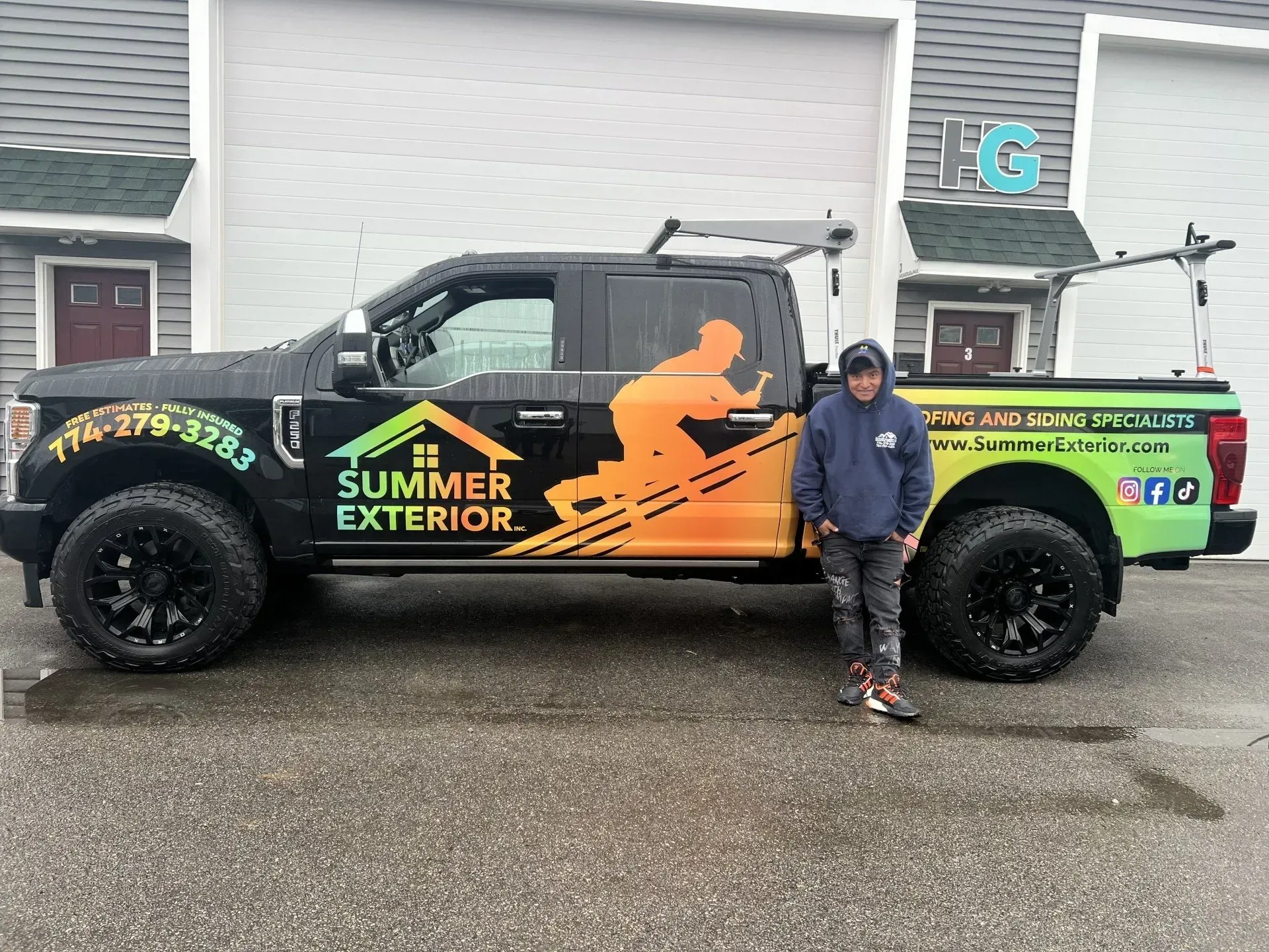 Man standing by a black truck with