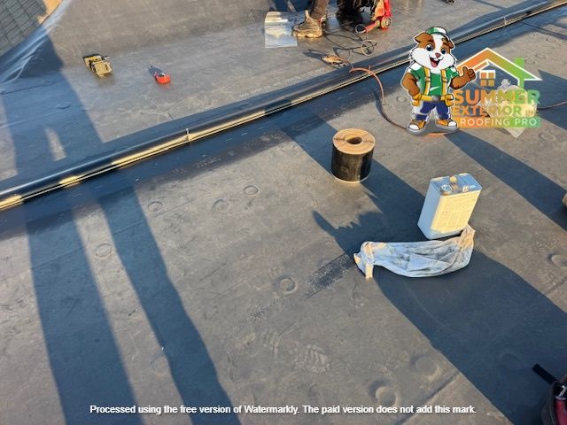 Roof being worked on, tools, electrical wire, dog mascot, sunny day.