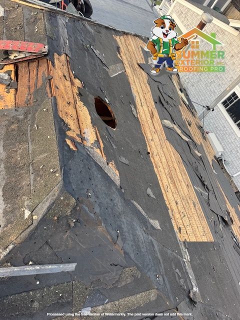 Damaged roof with missing shingles and exposed wooden underlayment.