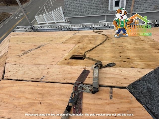 Rooftop with safety harness and logo of a smiling cartoon beaver.